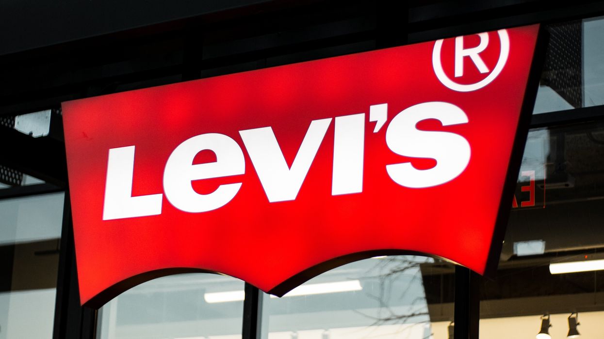 a levi's store sign is lit up at night