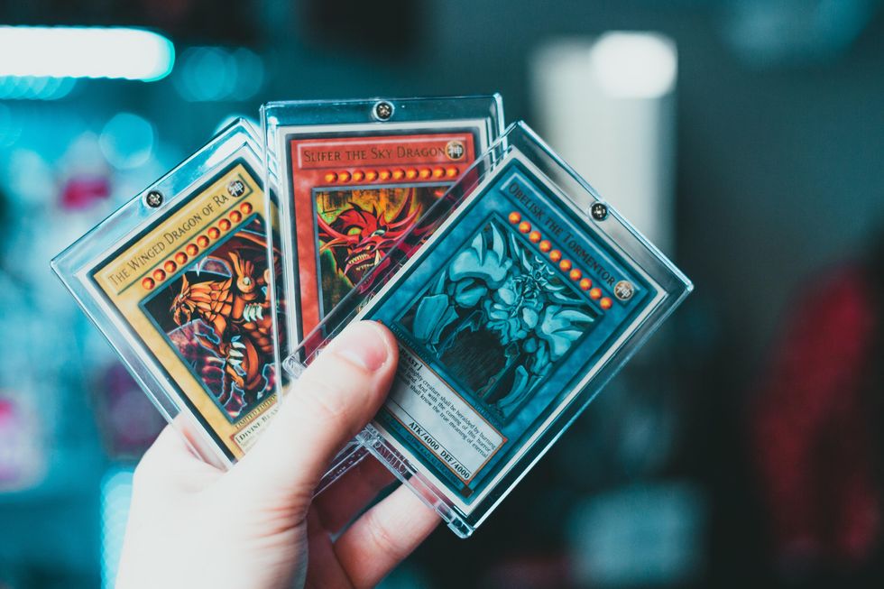 https://thecurrent.media/media-library/person-holding-yu-gi-oh-trading-card.jpg?id=31142519&width=980